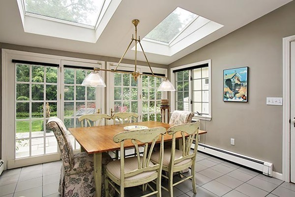 15 Bonad Road Newton, MA 02465 - Photo 7 of 16 a view of a dining room with furniture large windows and wooden floor