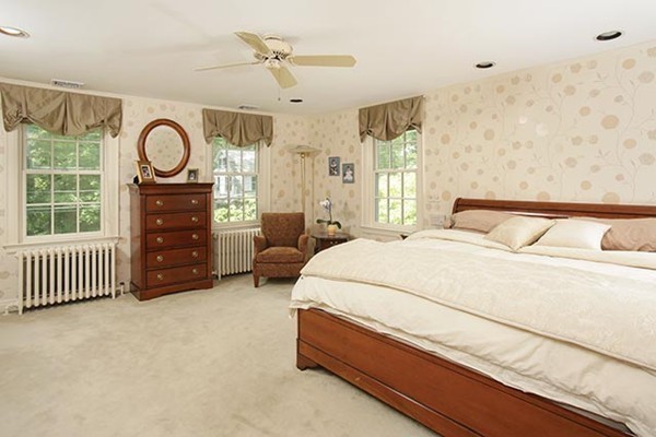 15 Bonad Road Newton, MA 02465 - Photo 9 of 16 a spacious bedroom with a bed a dresser and a large window
