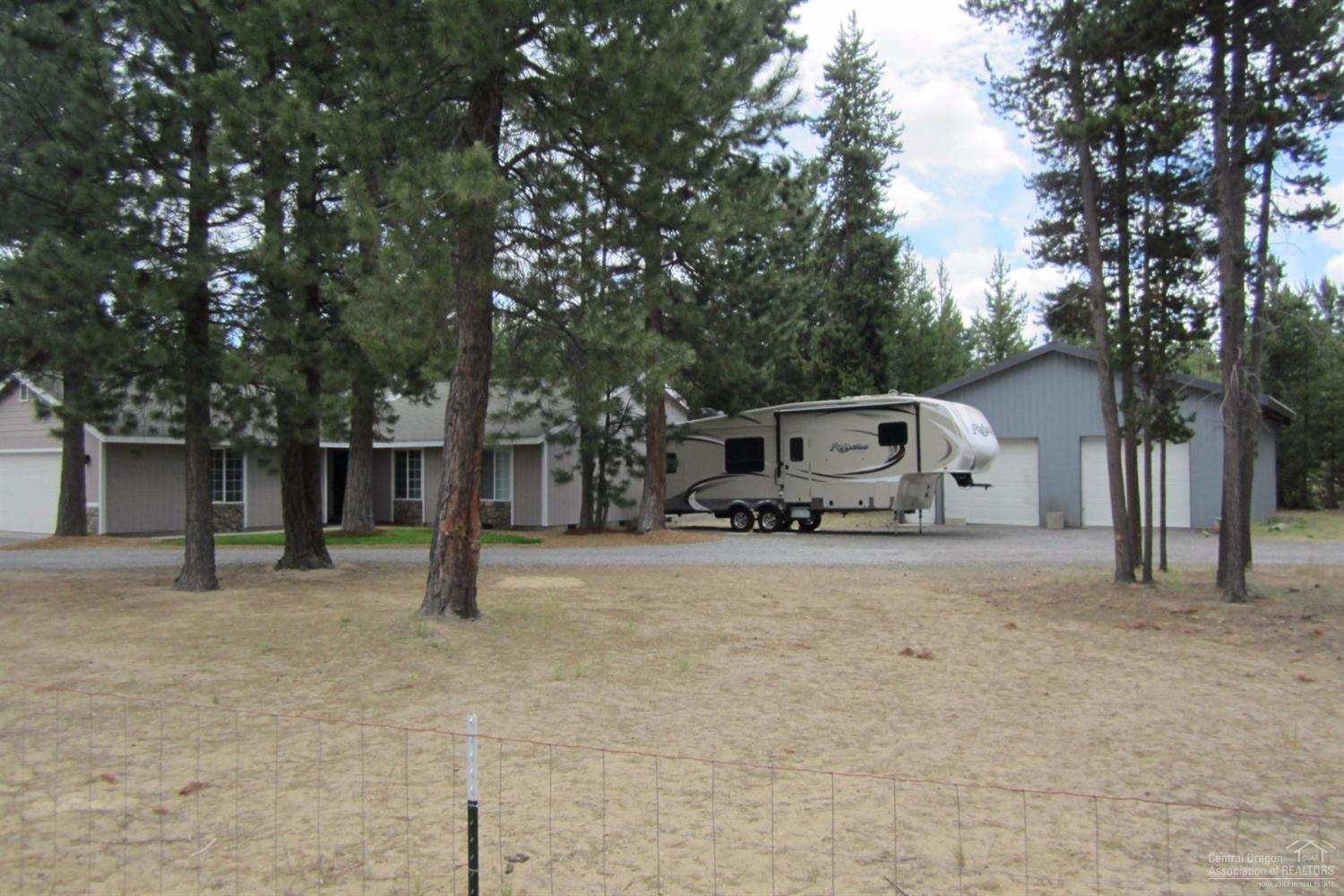17533 Rosland Road La Pine, OR 97739 - Photo 2 of 25 a house with trees in the background