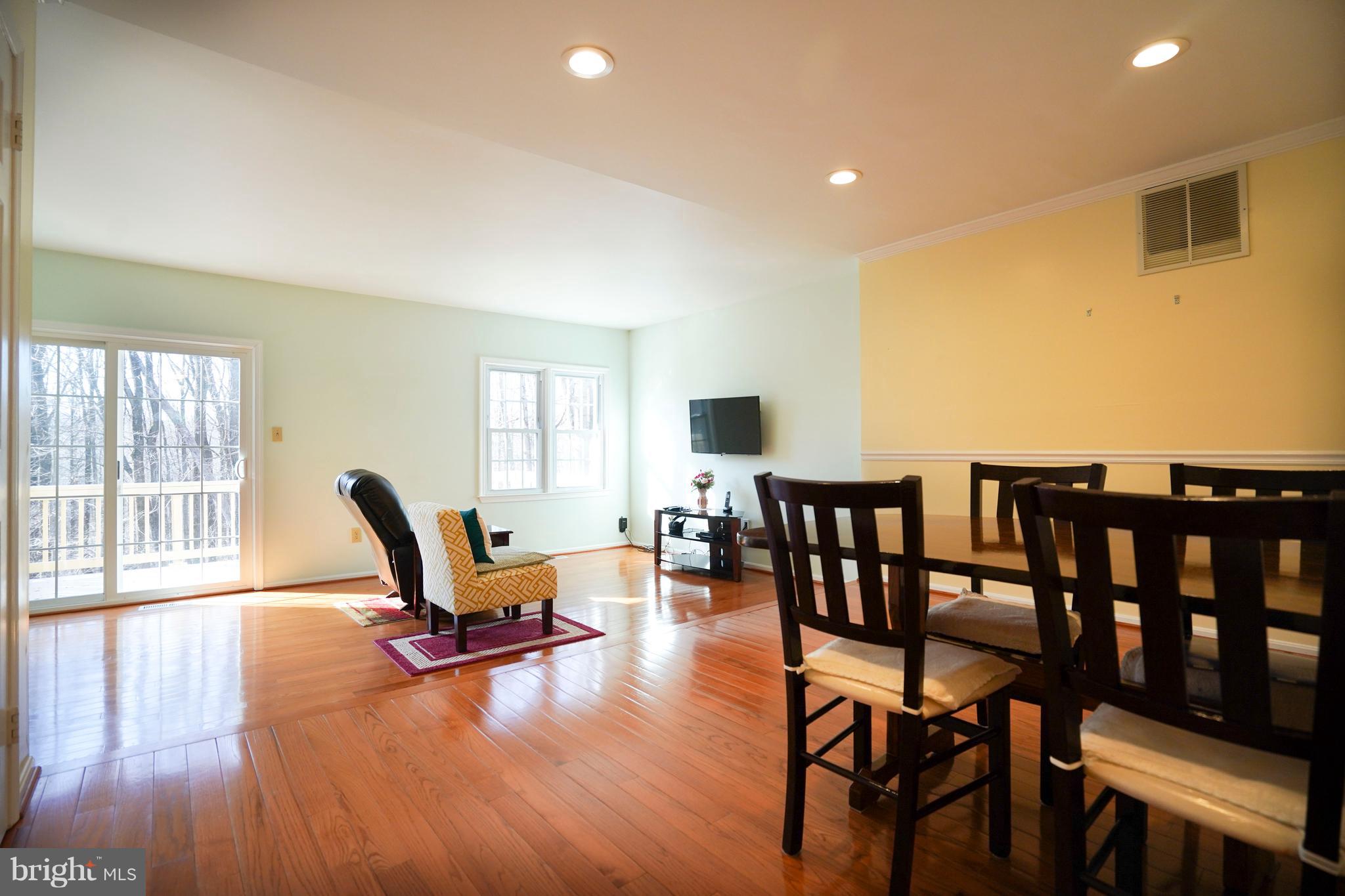 8836 Surveyors Place Springfield, VA 22152 - Photo 12 of 48 a living room with furniture and a wooden floor