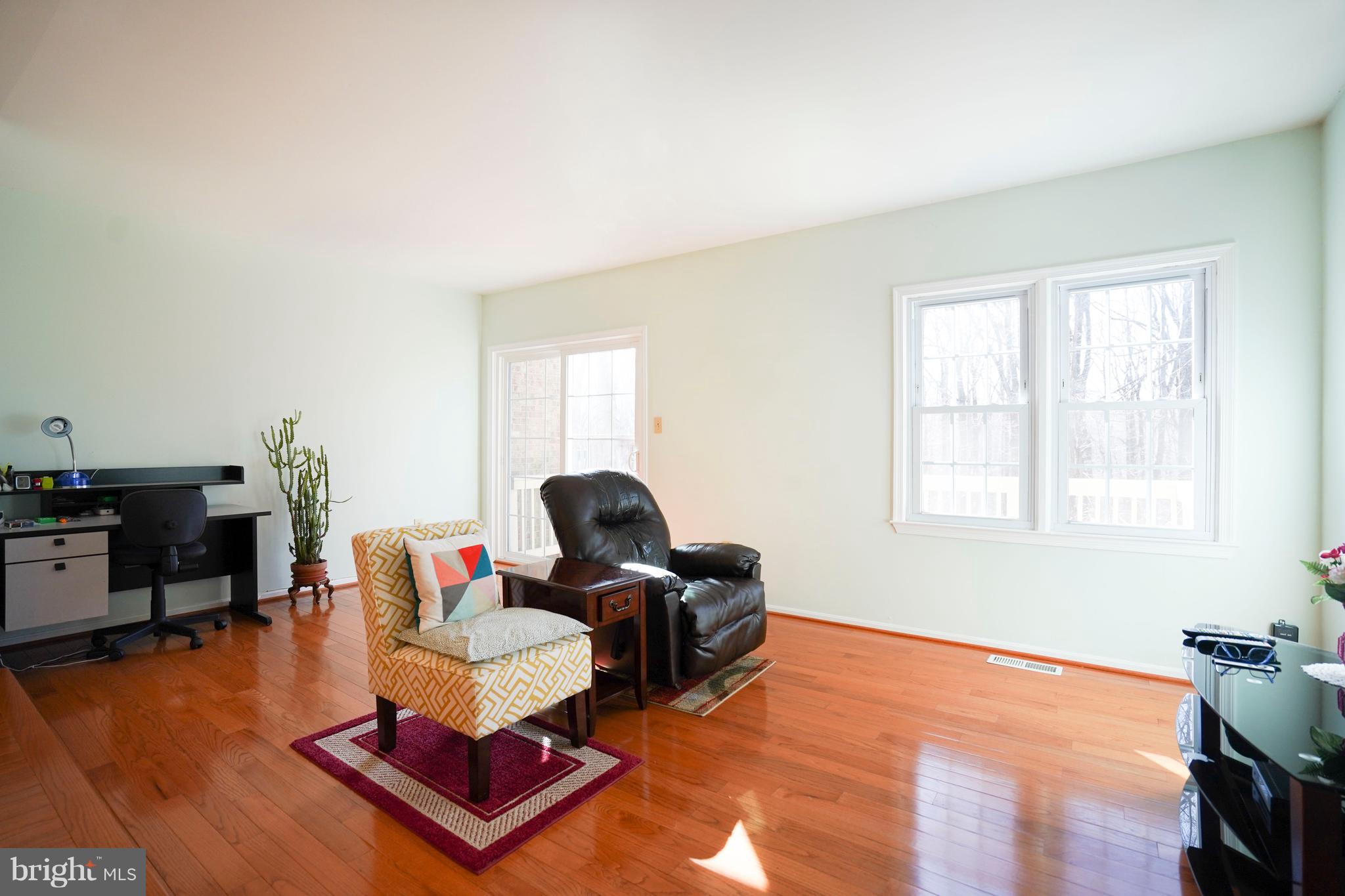 8836 Surveyors Place Springfield, VA 22152 - Photo 13 of 48 a living room with furniture and a wooden floor