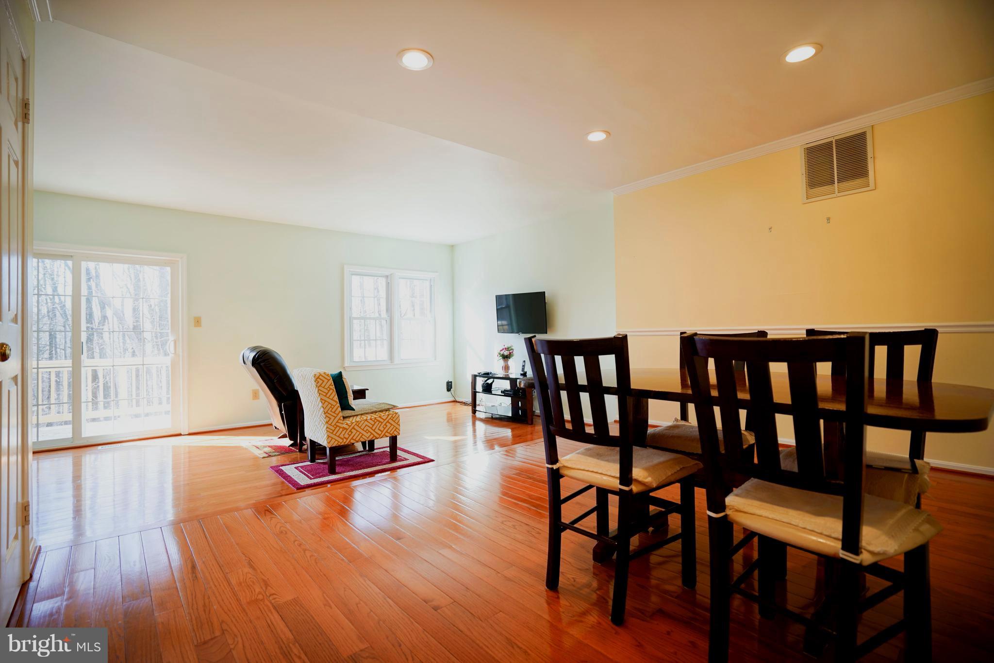 8836 Surveyors Place Springfield, VA 22152 - Photo 14 of 48 a view of a workspace with furniture and wooden floor