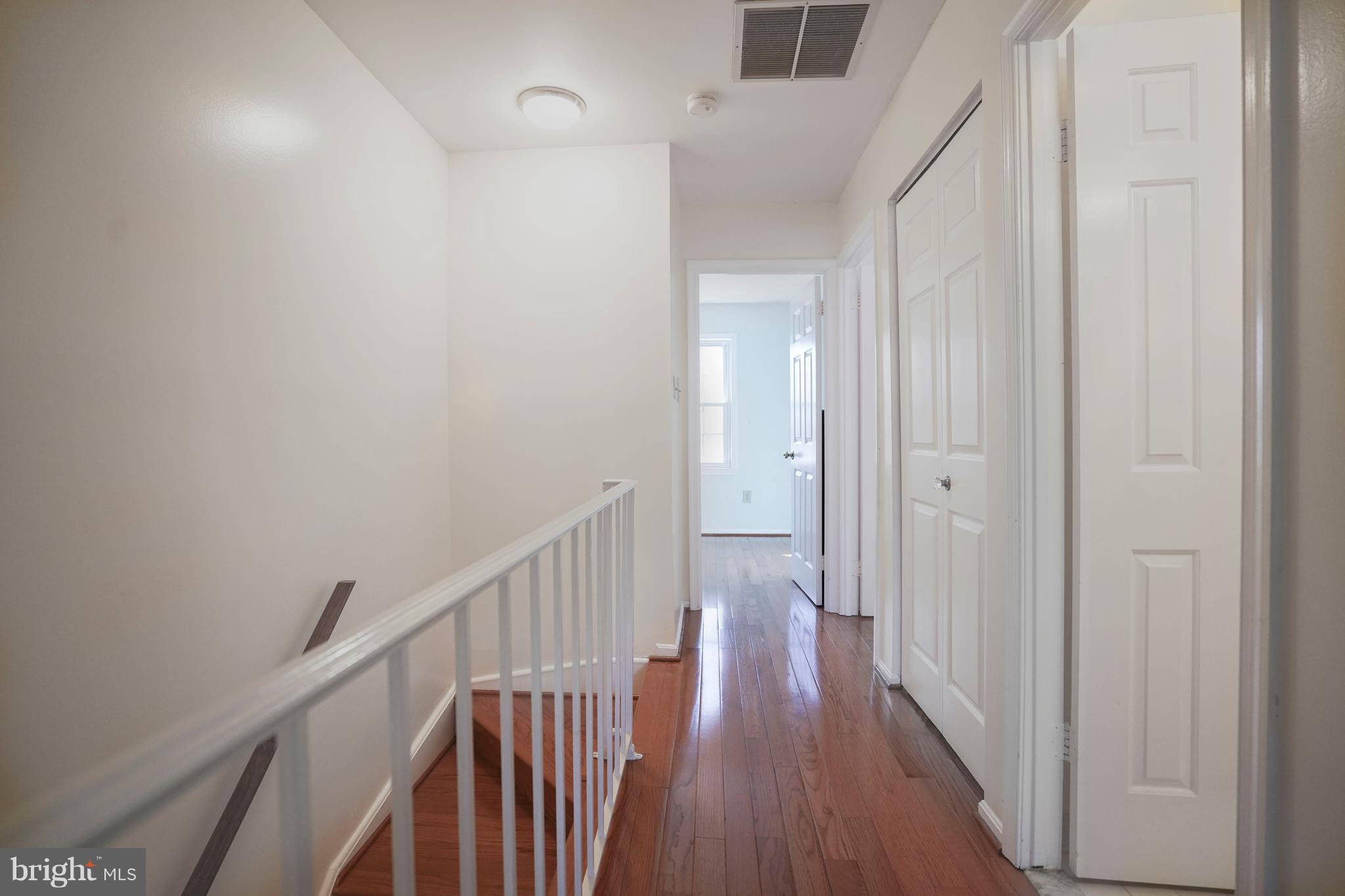 8836 Surveyors Place Springfield, VA 22152 - Photo 19 of 48 a view of a hallway with wooden floor