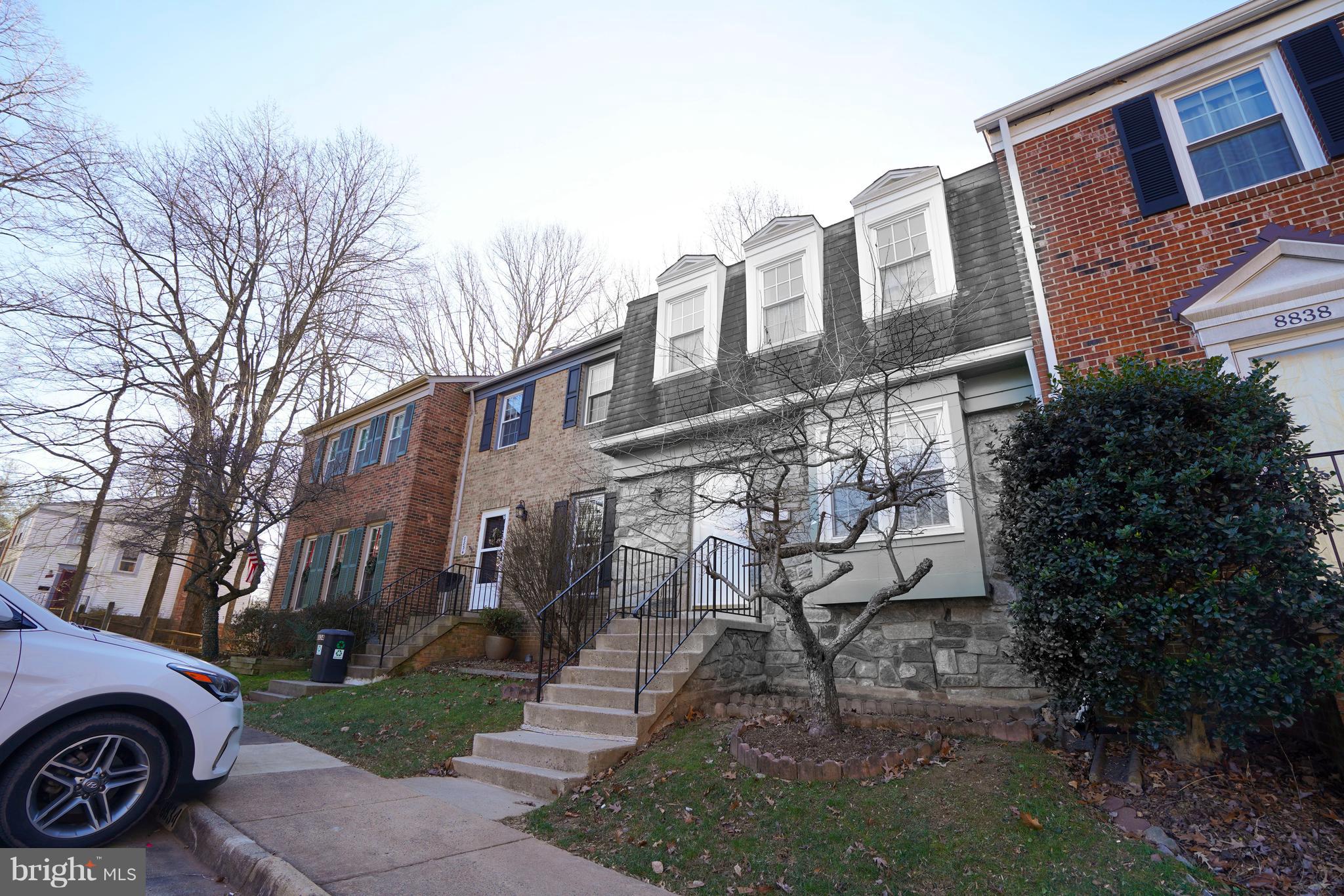 8836 Surveyors Place Springfield, VA 22152 - Photo 3 of 48 a view of a building with a yard