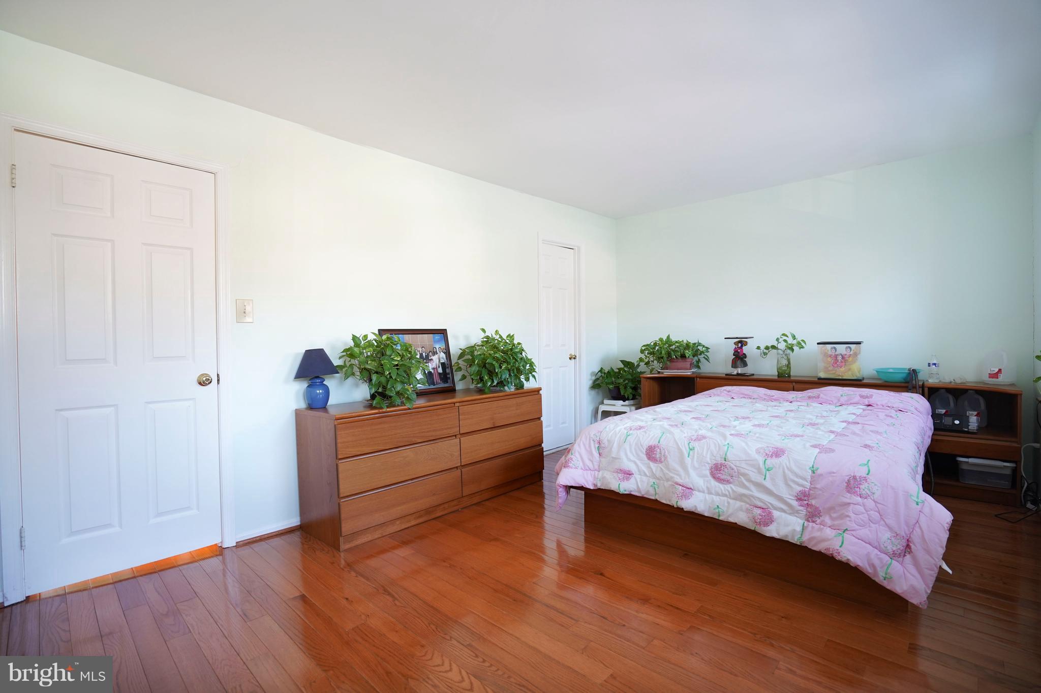 8836 Surveyors Place Springfield, VA 22152 - Photo 21 of 48 a bedroom with a bed and a dresser