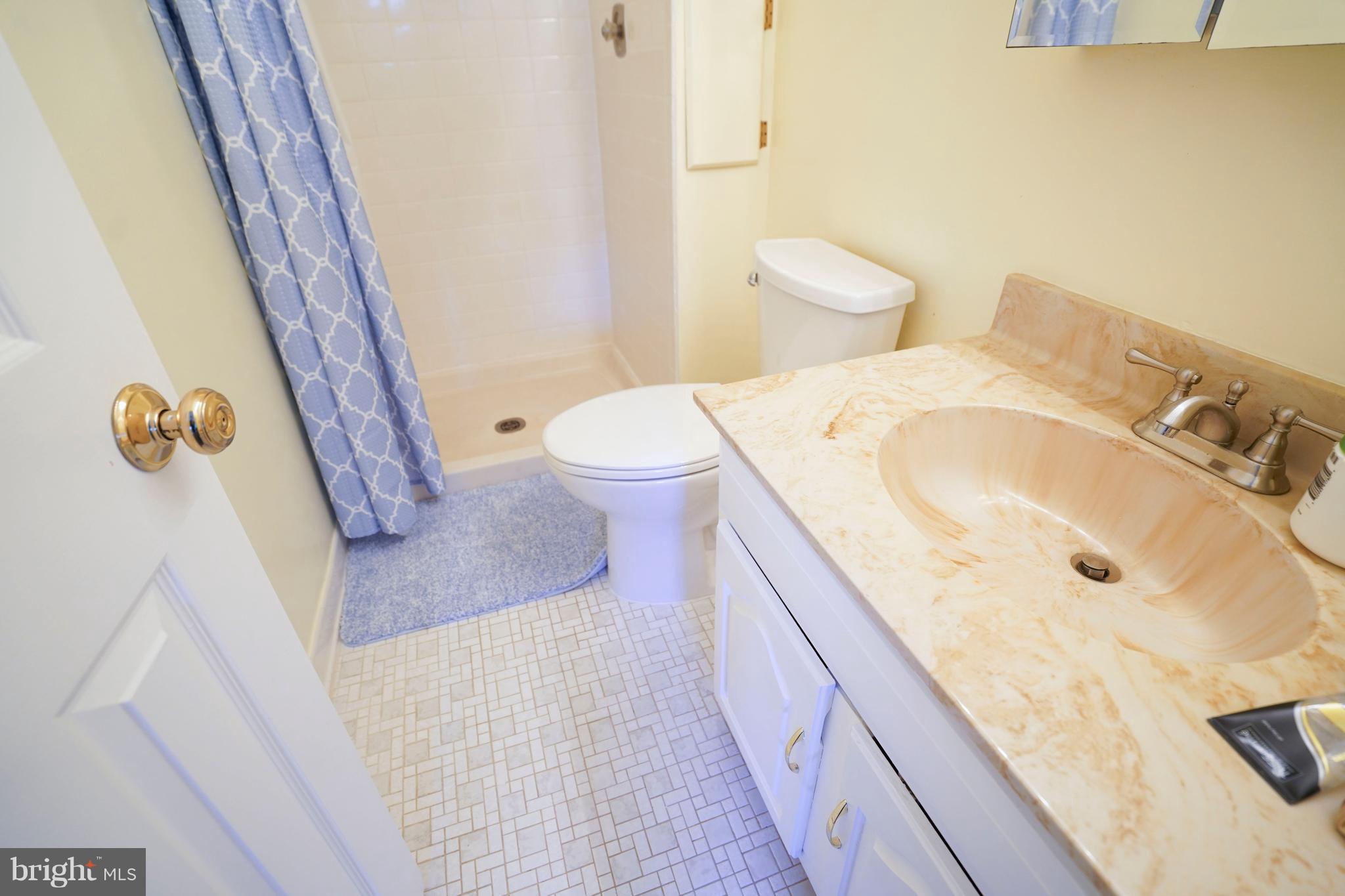 8836 Surveyors Place Springfield, VA 22152 - Photo 24 of 48 a bathroom with a granite countertop sink and a mirror
