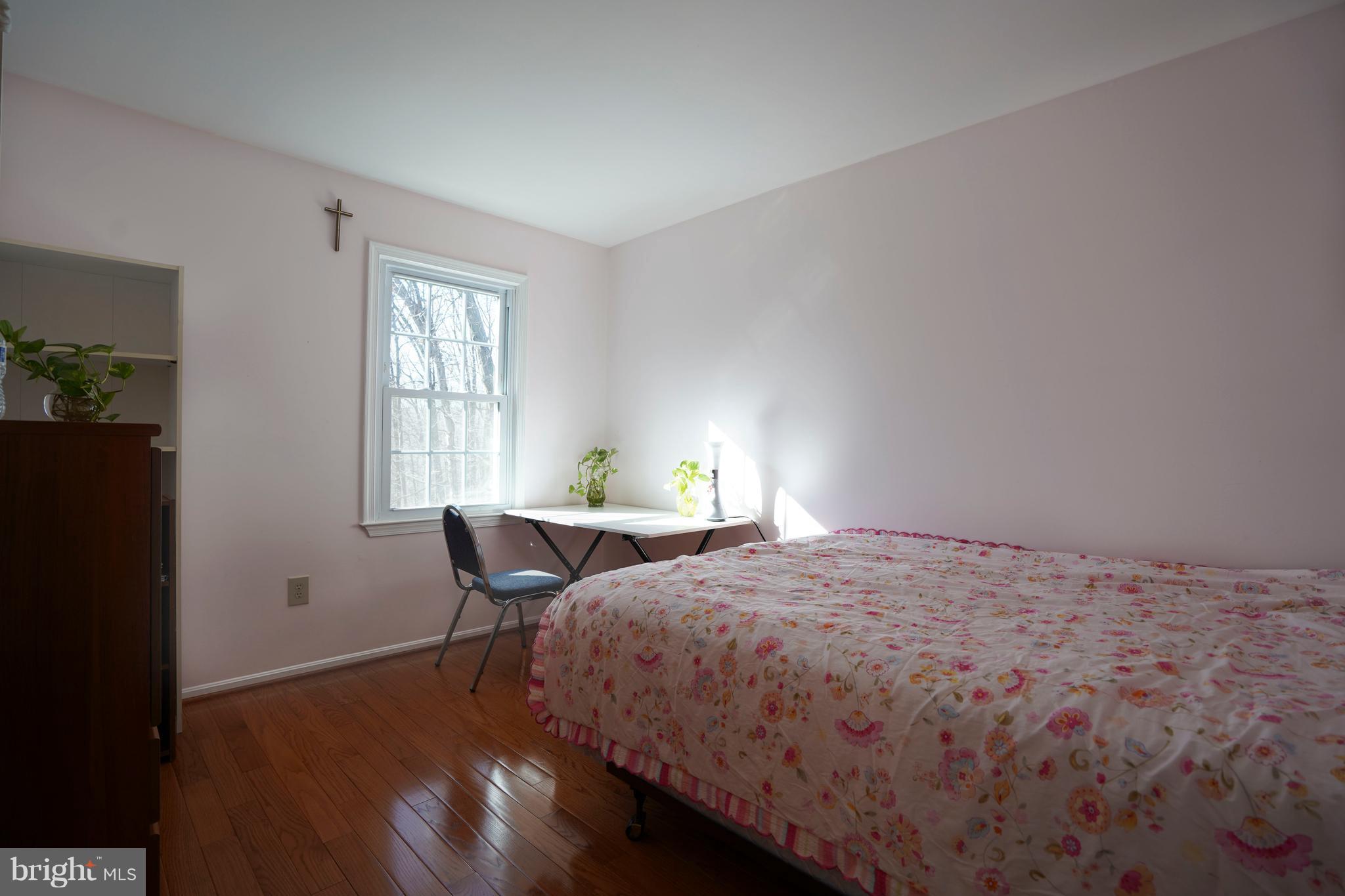 8836 Surveyors Place Springfield, VA 22152 - Photo 25 of 48 a bedroom with a bed chair and window
