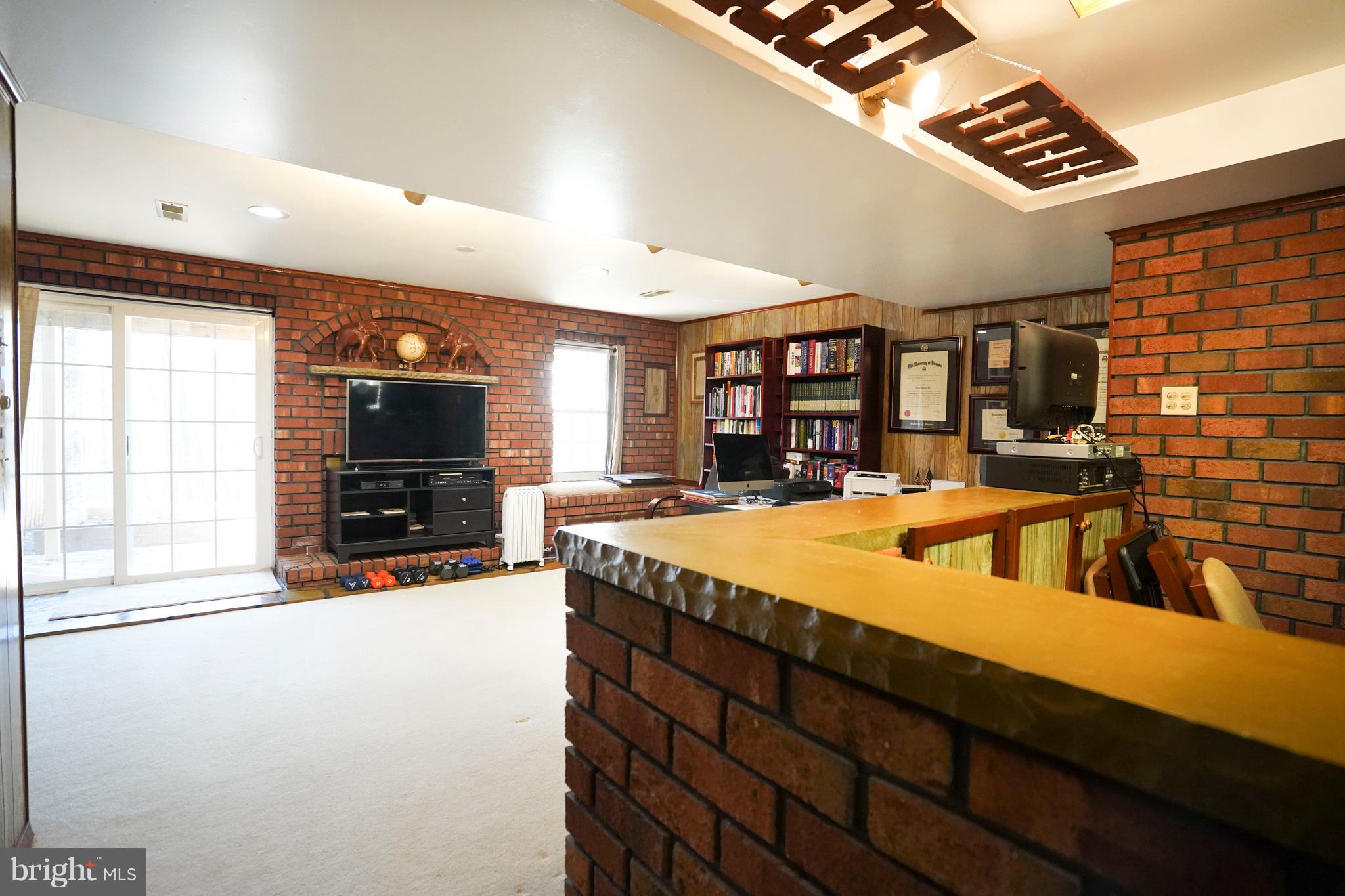 8836 Surveyors Place Springfield, VA 22152 - Photo 34 of 48 a view of a kitchen with furniture and a flat screen tv