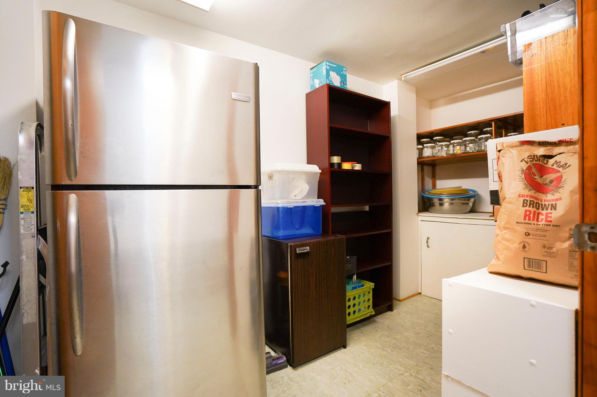 8836 Surveyors Place Springfield, VA 22152 - Photo 35 of 48 a view of storage and utility room with refrigerator and washer