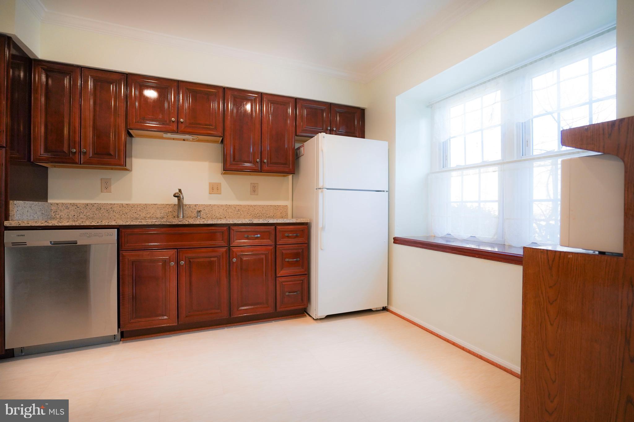 8836 Surveyors Place Springfield, VA 22152 - Photo 7 of 48 a kitchen with stainless steel appliances granite countertop a refrigerator a sink and dishwasher