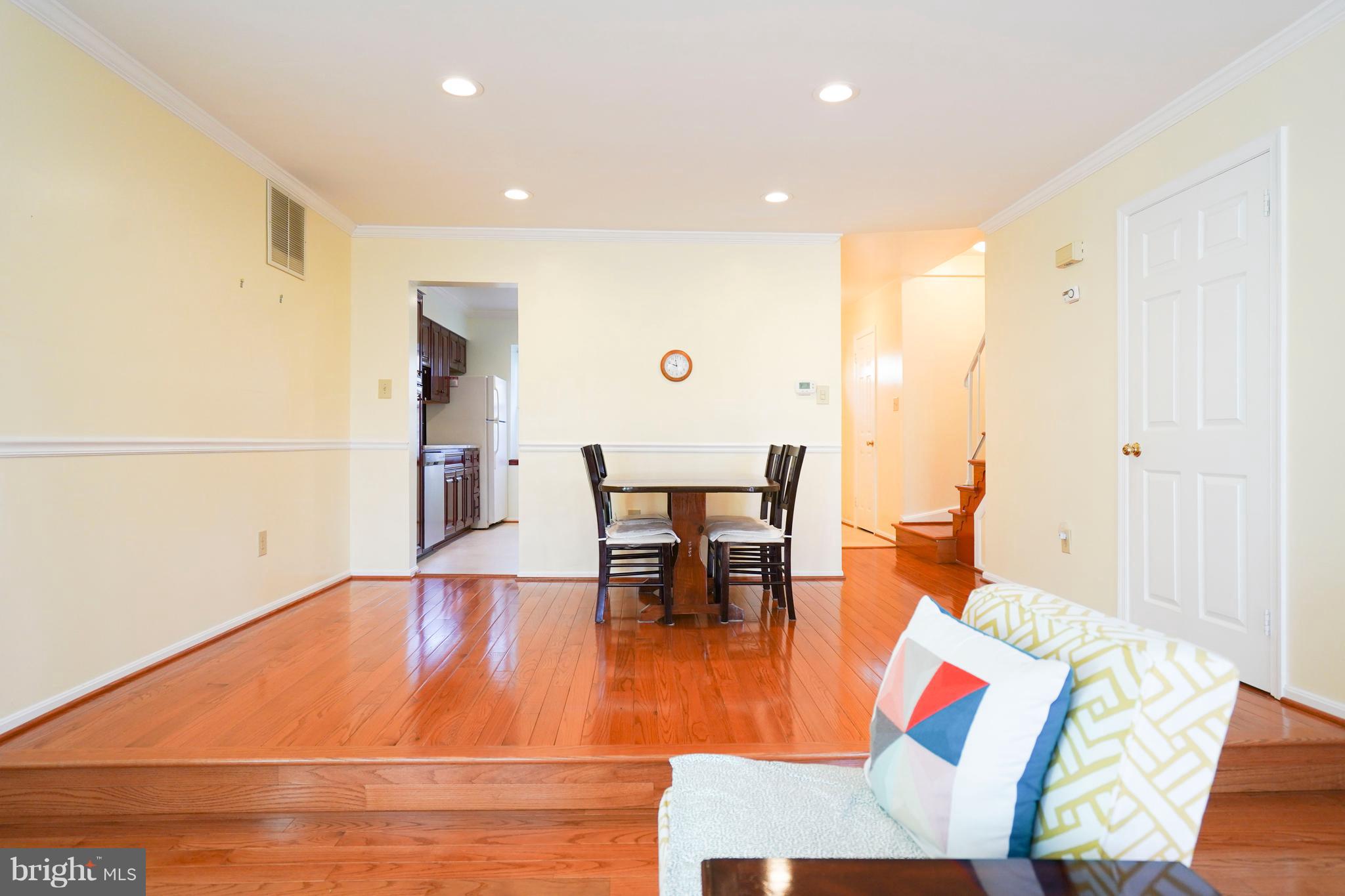 8836 Surveyors Place Springfield, VA 22152 - Photo 9 of 48 a living room with dining room and wooden floor