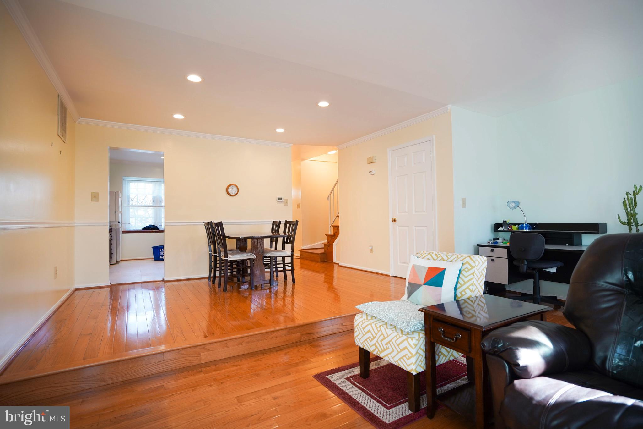 8836 Surveyors Place Springfield, VA 22152 - Photo 10 of 48 a living room with furniture and a dining table with kitchen view