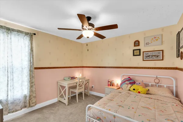 a bedroom with a bed and a book shelf