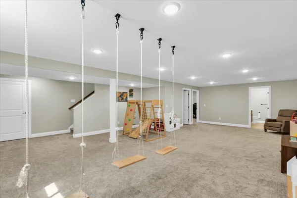 a view of a room with gym equipment and a flat screen tv