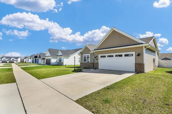 a view of a house with a yard and garage