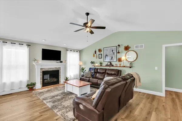 a living room with furniture and kitchen view