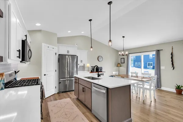 a kitchen with sink a stove and chairs