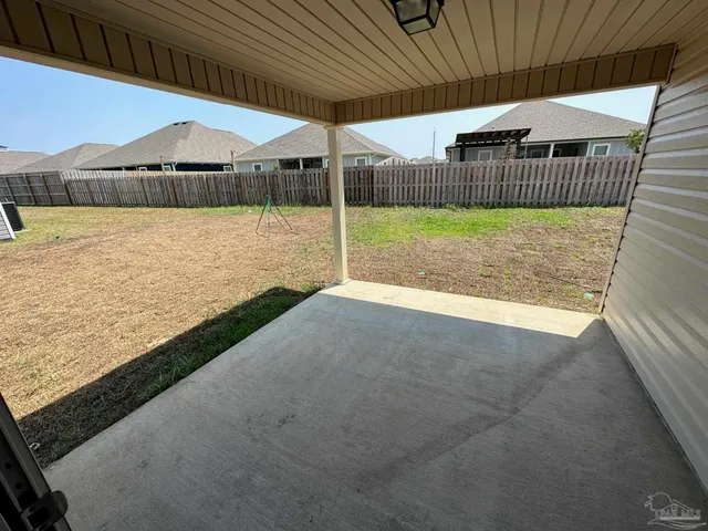 a view of a house with a yard from a balcony