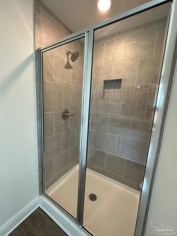 a bathroom with a shower and a bath tub