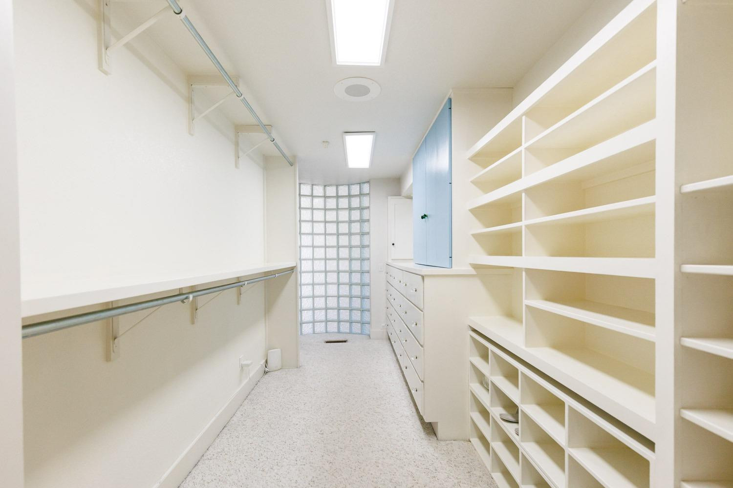 4603 94th Street Lubbock, TX 79424 - Photo 16 of 46 a view of walk in closet with empty racks