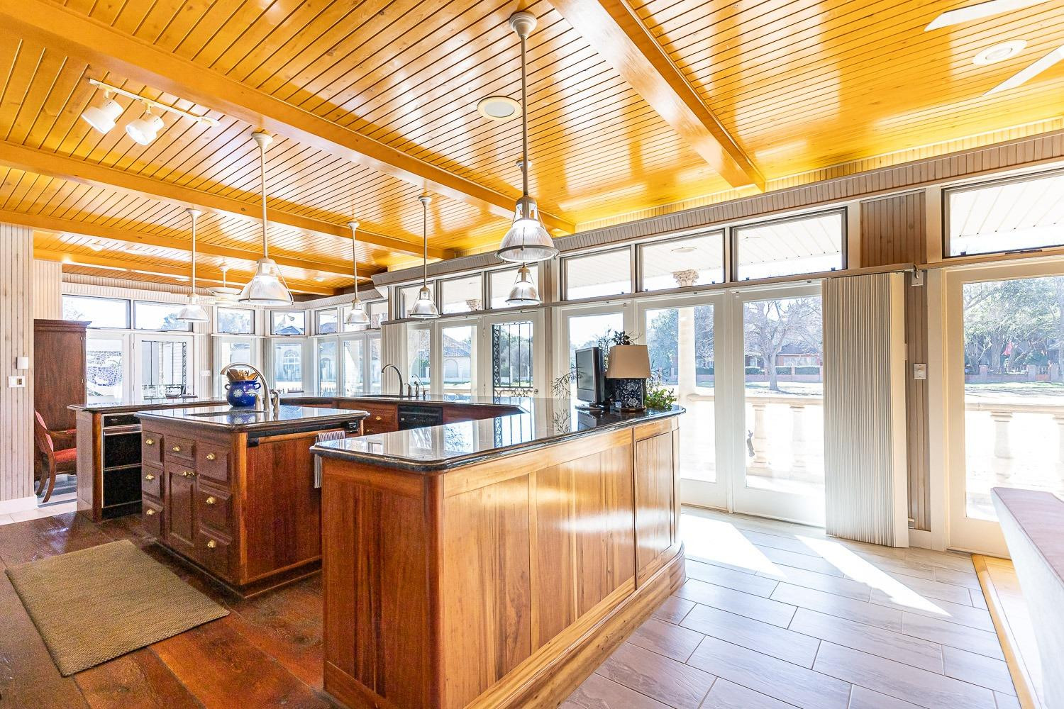 4603 94th Street Lubbock, TX 79424 - Photo 17 of 46 a view of a kitchen with kitchen island granite countertop a large window