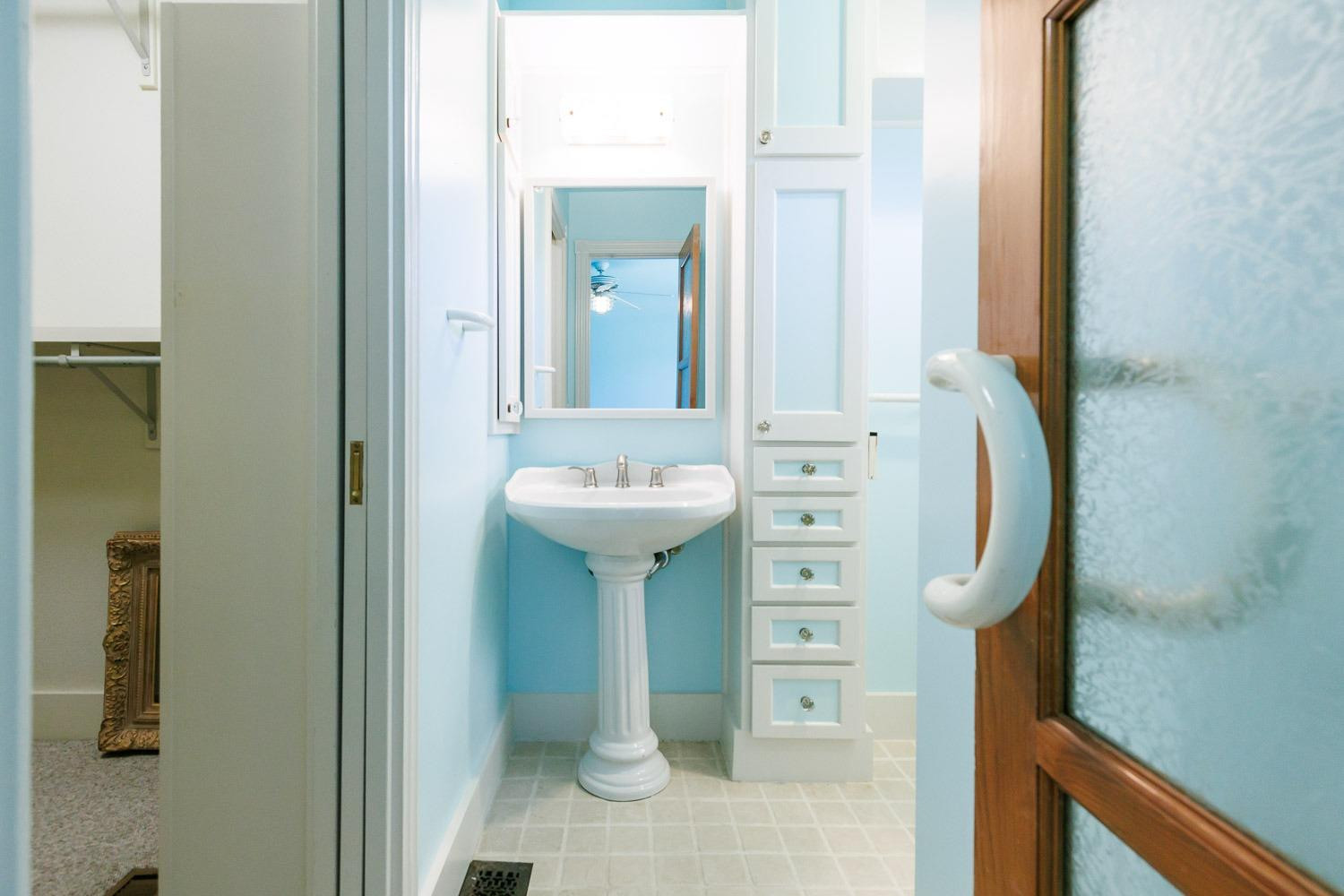 4603 94th Street Lubbock, TX 79424 - Photo 28 of 46 a bathroom with a sink and a mirror