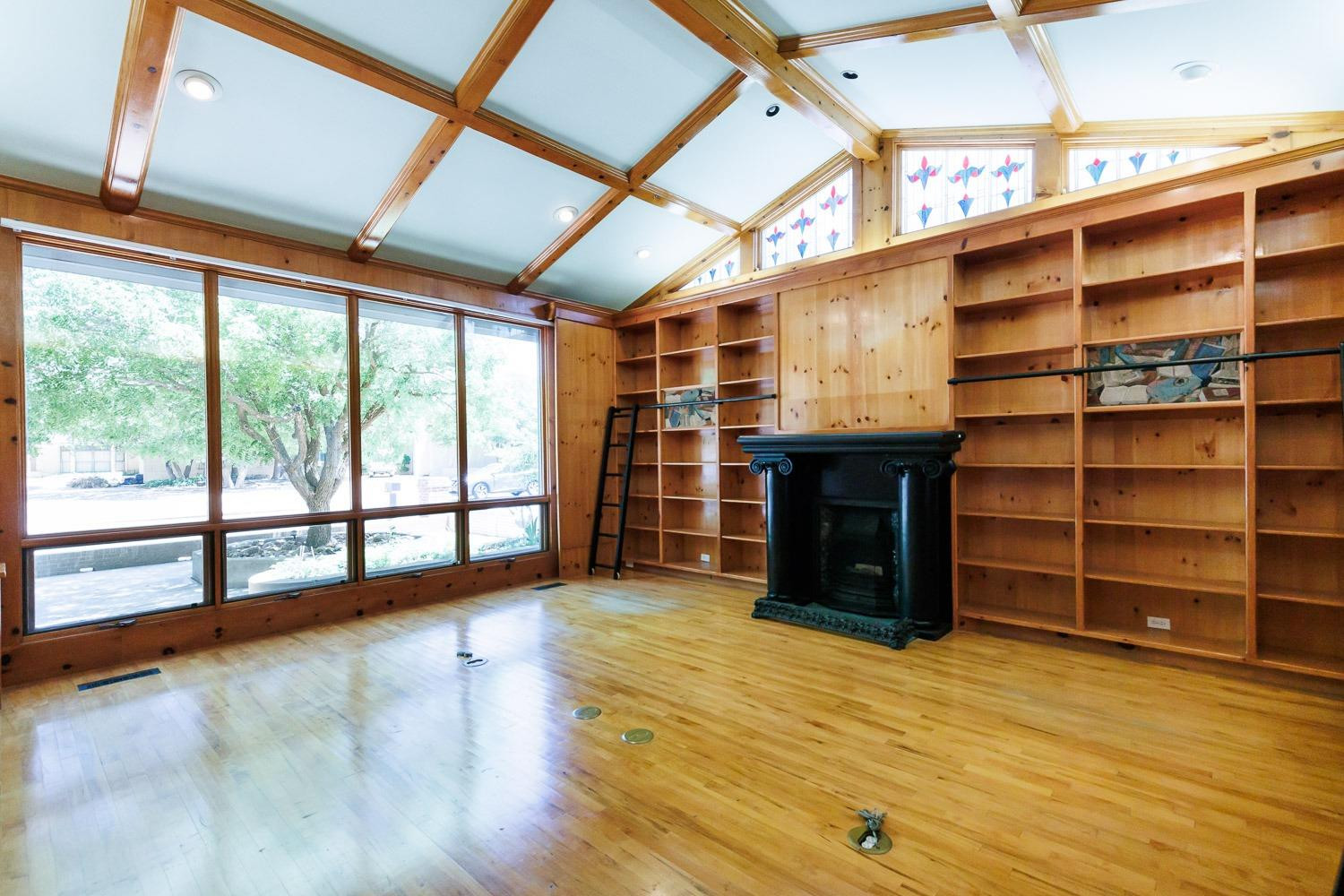 4603 94th Street Lubbock, TX 79424 - Photo 9 of 46 a view of an empty room with a window and wooden floor