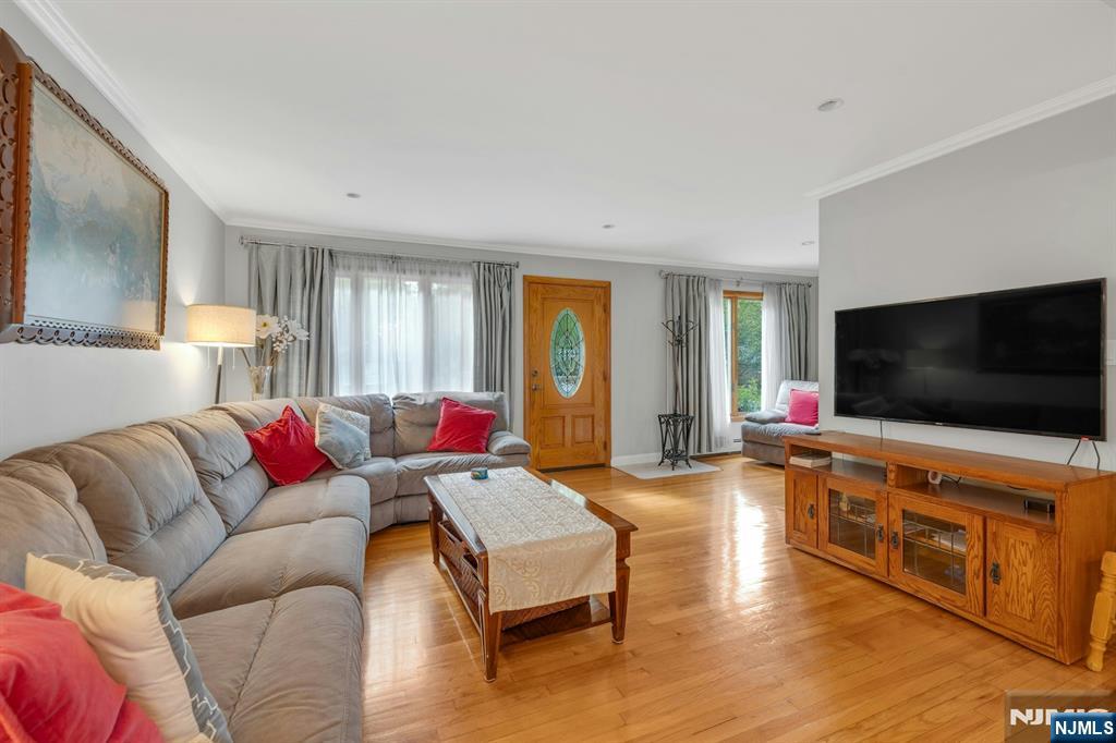 24 Cambridge Road Tenafly, NJ 07670 - Photo 11 of 31 a living room with furniture and a flat screen tv