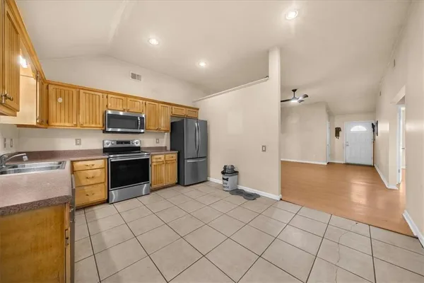 a kitchen with stainless steel appliances a refrigerator sink and cabinets