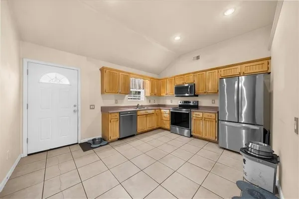 a kitchen with a refrigerator sink and microwave