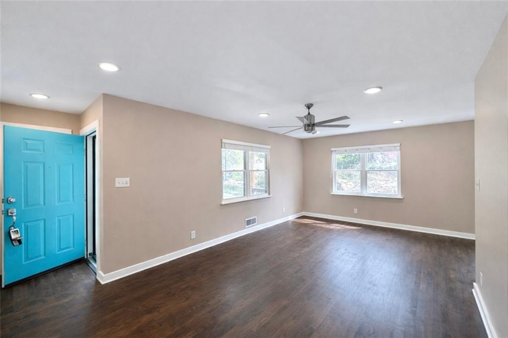 1291 Lorenzo Drive Southwest Atlanta, GA 30310 - Photo 4 of 20 an empty room with wooden floor chandelier and windows