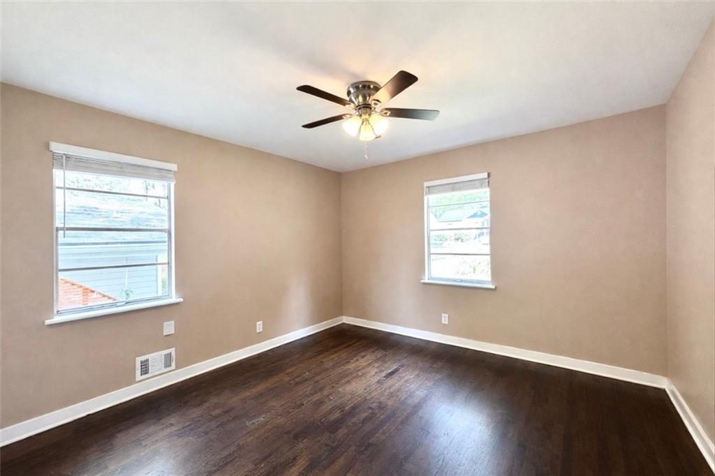 1291 Lorenzo Drive Southwest Atlanta, GA 30310 - Photo 10 of 20 a view of a livingroom with a fan a large window with wooden floor