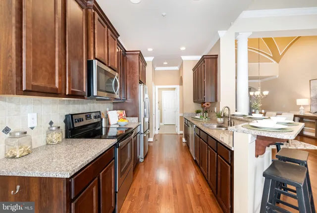 a kitchen with a sink stove top oven and cabinets