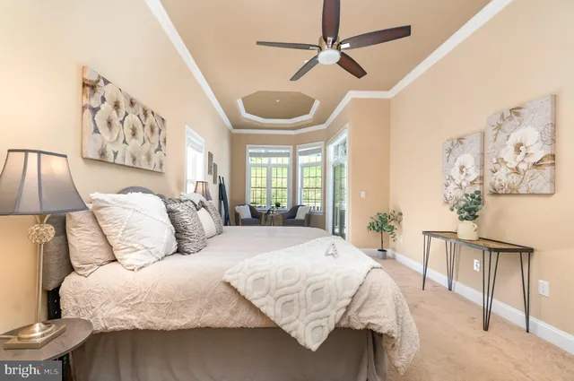 a bedroom with a large bed and a chandelier