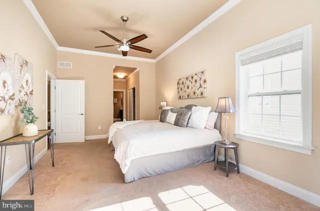 a spacious bedroom with a bed and a window