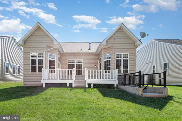 a view of a house with a yard and sitting area