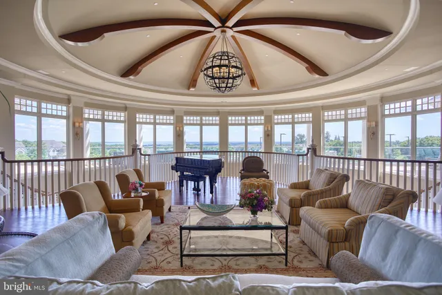 a room with pool table and windows