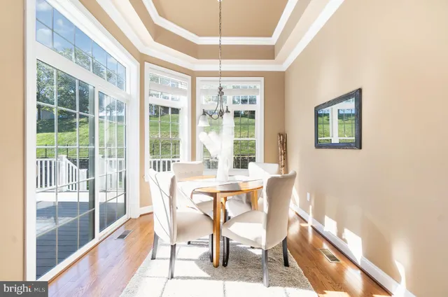 a dining room with furniture and large windows