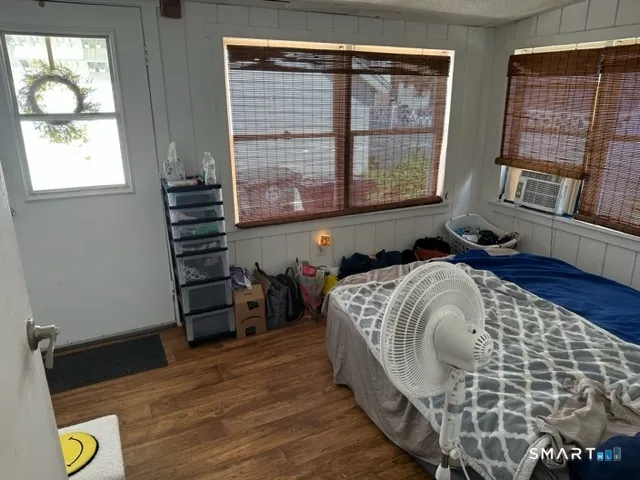 a bed sitting in a bedroom next to a window