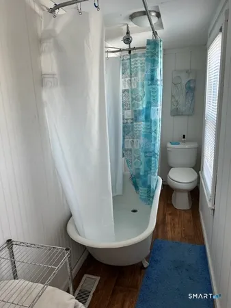 a bathroom with a shower and a toilet