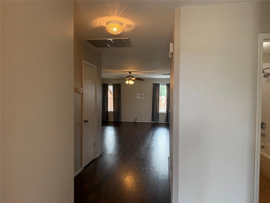 4514 Quail Run Road Sherman, TX 75092 - Photo 2 of 34 Corridor with dark wood-style flooring and baseboards