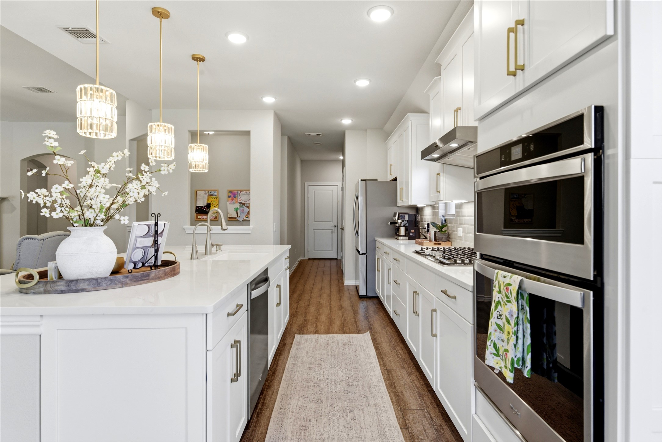 17834 Maple Ash Drive Spring, TX 77379 - Photo 14 of 50 Kitchen has an abundance of lighting from beautiful crystal/gold pendants to overhead can lights in addition to under counter lighting.