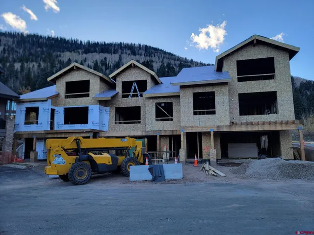 a view of a wooden fence and trees