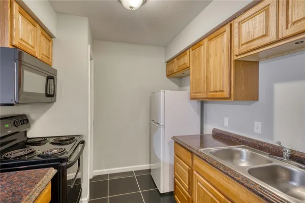 a kitchen that has a sink and a stove