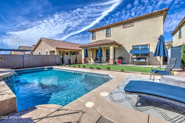 a view of house with swimming pool outdoor seating
