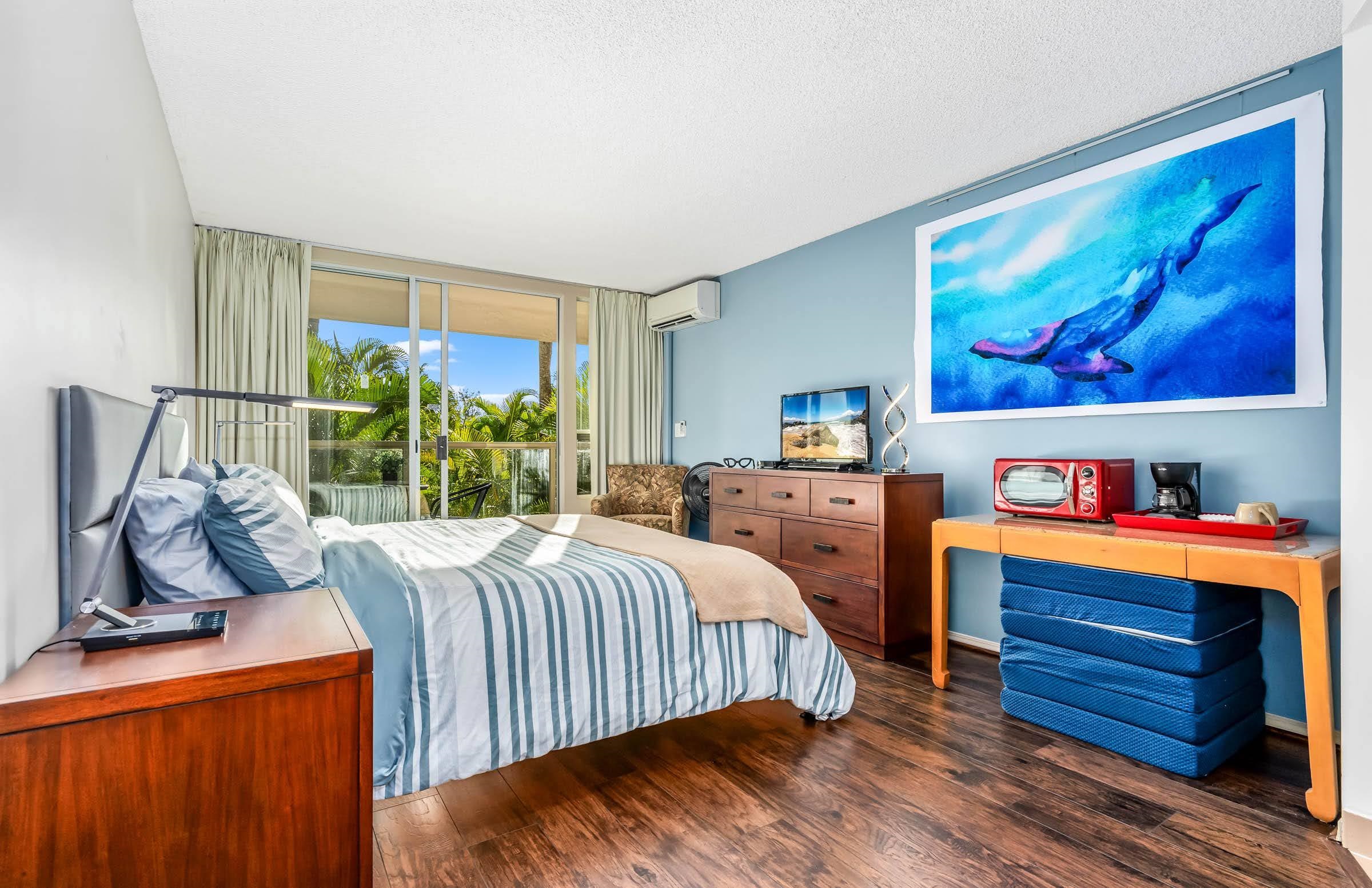 2575 South Kihei Road, Unit G209 Kihei, HI 96753 - Photo 17 of 27 a bedroom with a bed and wooden floor