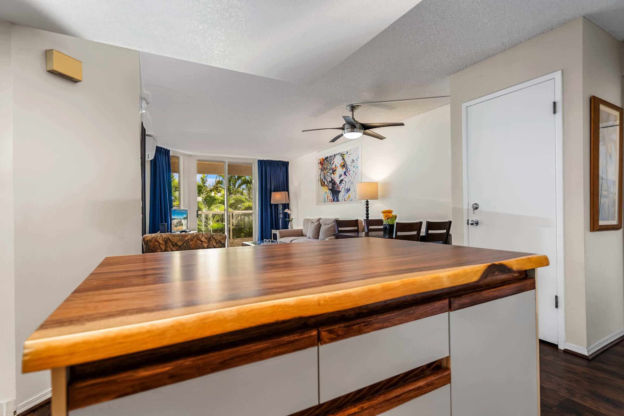 2575 South Kihei Road, Unit G209 Kihei, HI 96753 - Photo 4 of 27 a view living room with kitchen island stainless steel appliances a sink and wooden floor