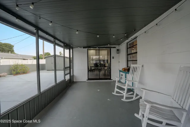 a view of a room with wooden floor outdoor seating and windows