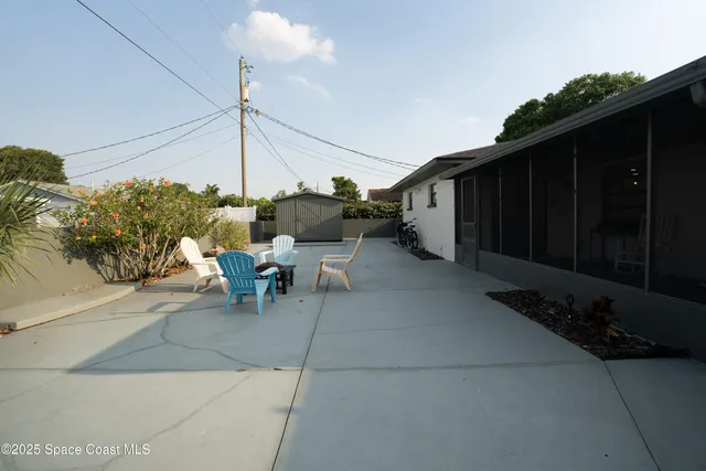 a view of a patio with table and chairs potted plants with wooden fence