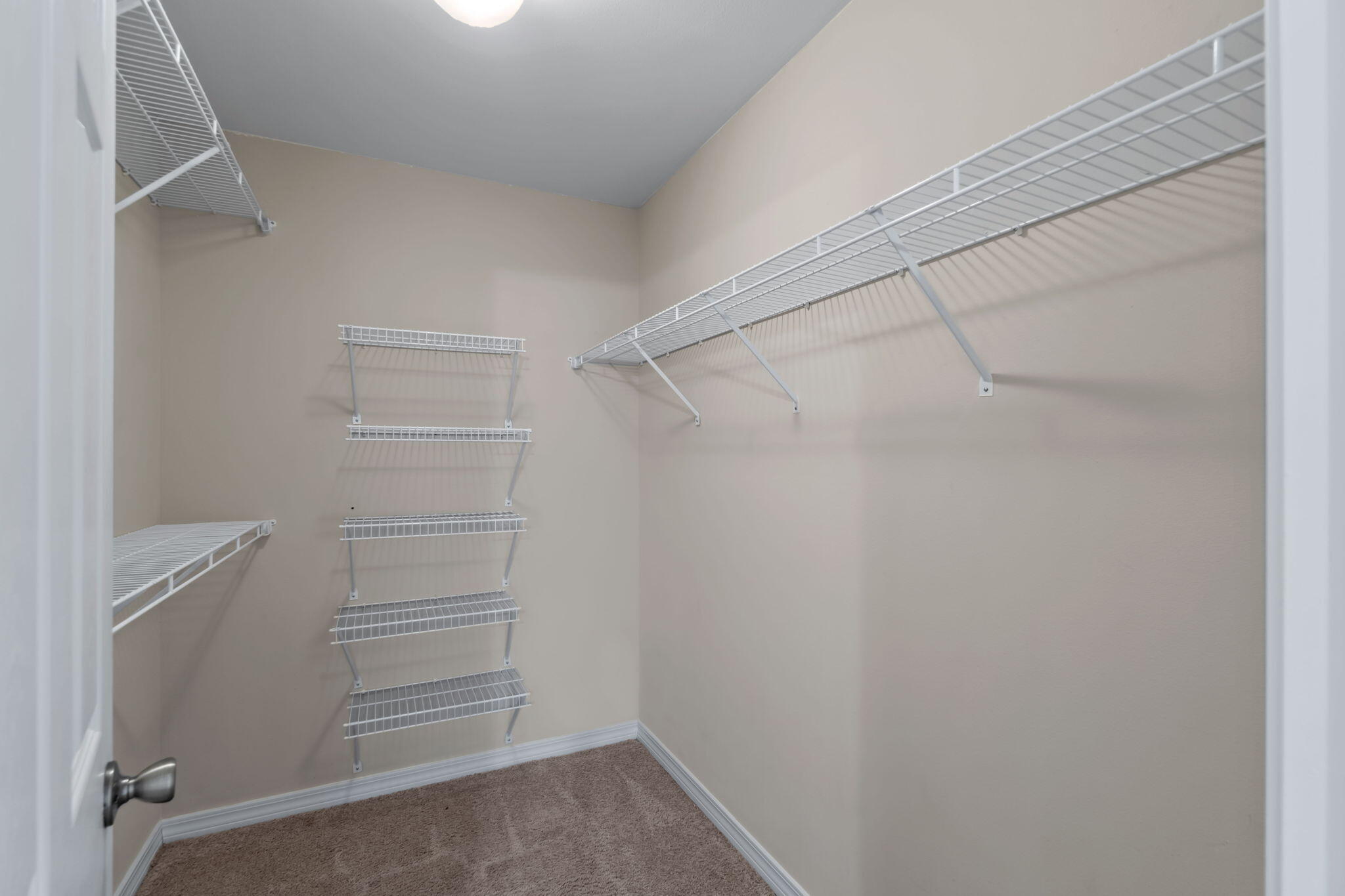 218 Cabana Way Crestview, FL 32536 - Photo 26 of 35 a view of walk in closet with empty racks